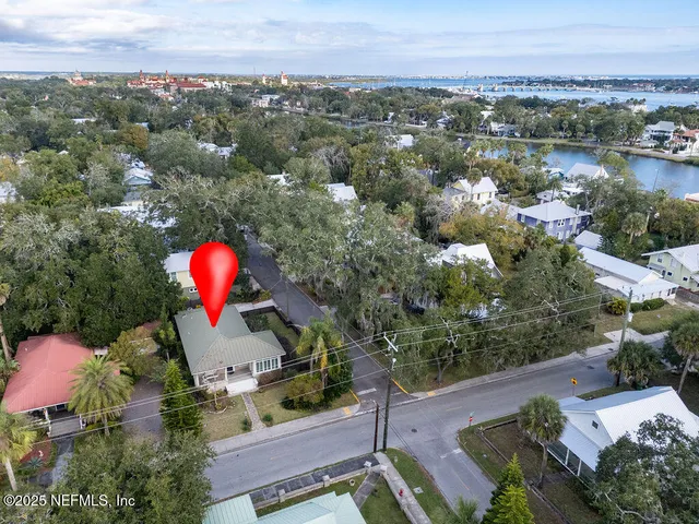 an aerial view of a house with a swimming pool outdoor seating and yard