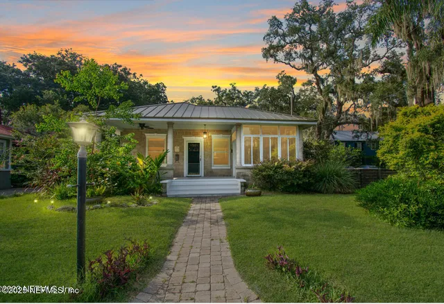 a front view of a house with garden