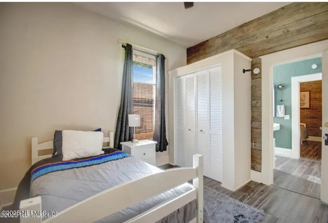 a bedroom with a bed and a mirror