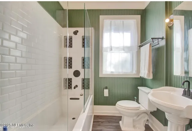a bathroom with a toilet sink and shower