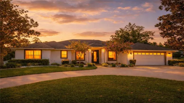 a front view of house with yard and green space