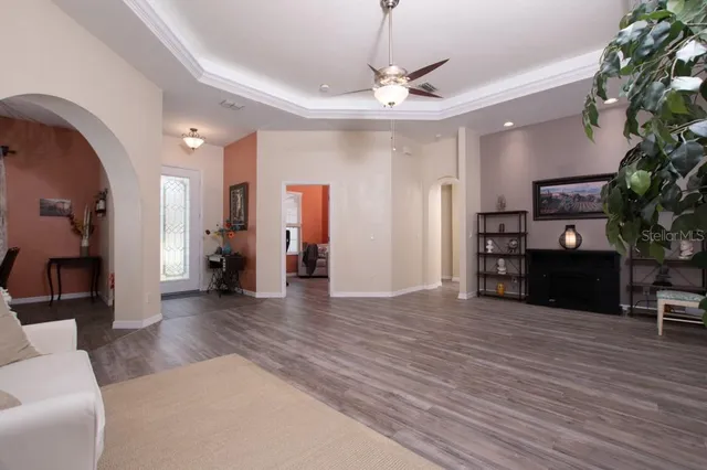 a living room with furniture and kitchen view