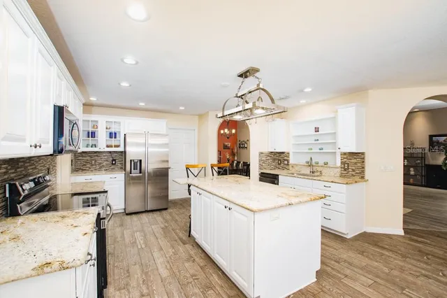 a living room with furniture a flat screen tv and a large window