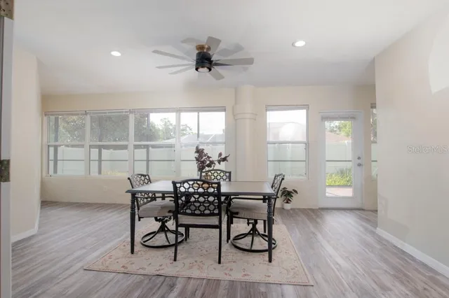 a bedroom with a bed windows and a rug