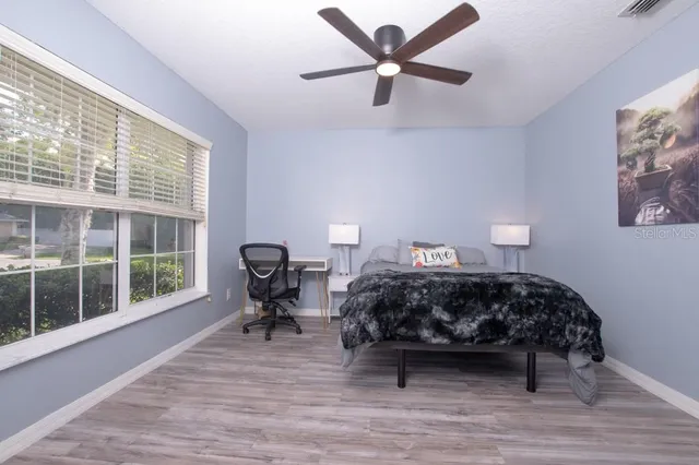 a swimming pool with yard in the back