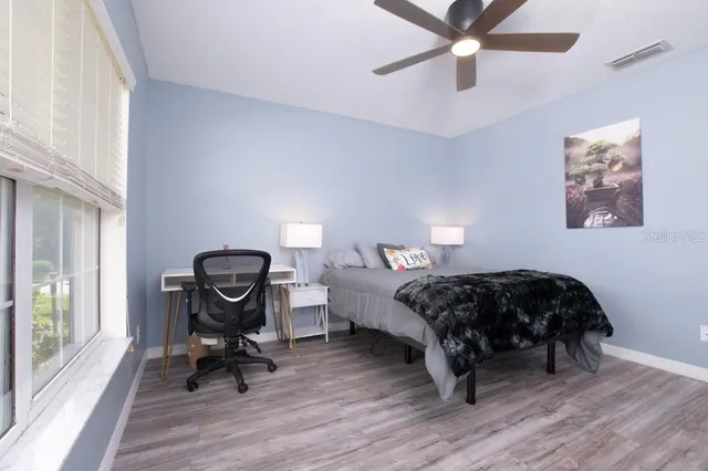 a view of roof deck with table and chairs
