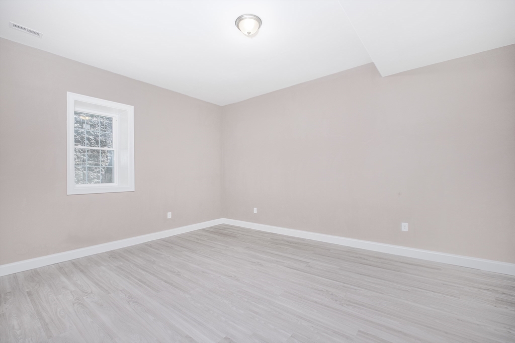 216 Vane Street, Unit 2 Revere, MA 02151 - Photo 8 of 22 a view of an empty room with wooden floor and a window