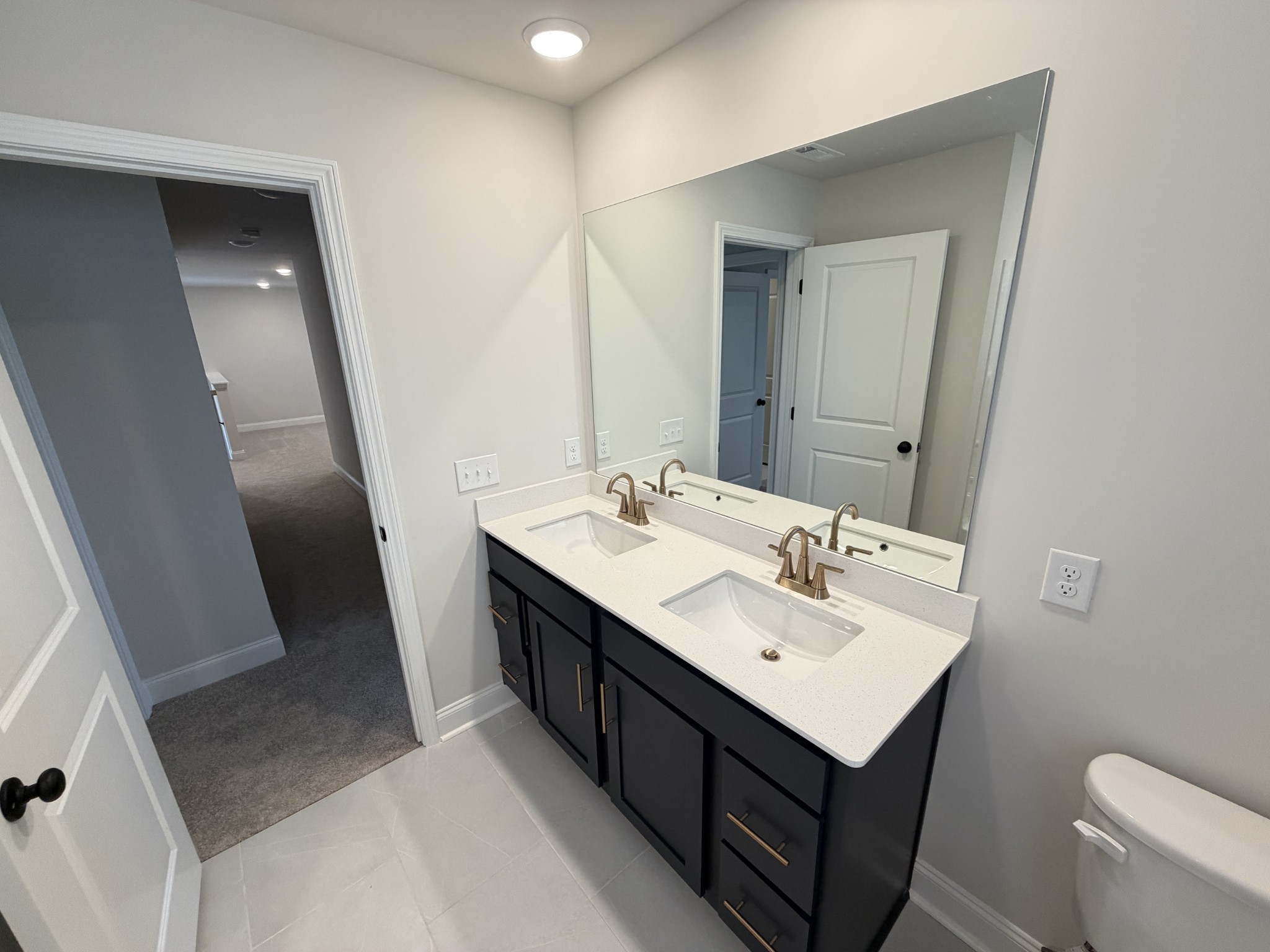 147 Emeline Way Mount Juliet, TN 37122 - Photo 28 of 41 a bathroom with a sink a toilet a mirror and vanity