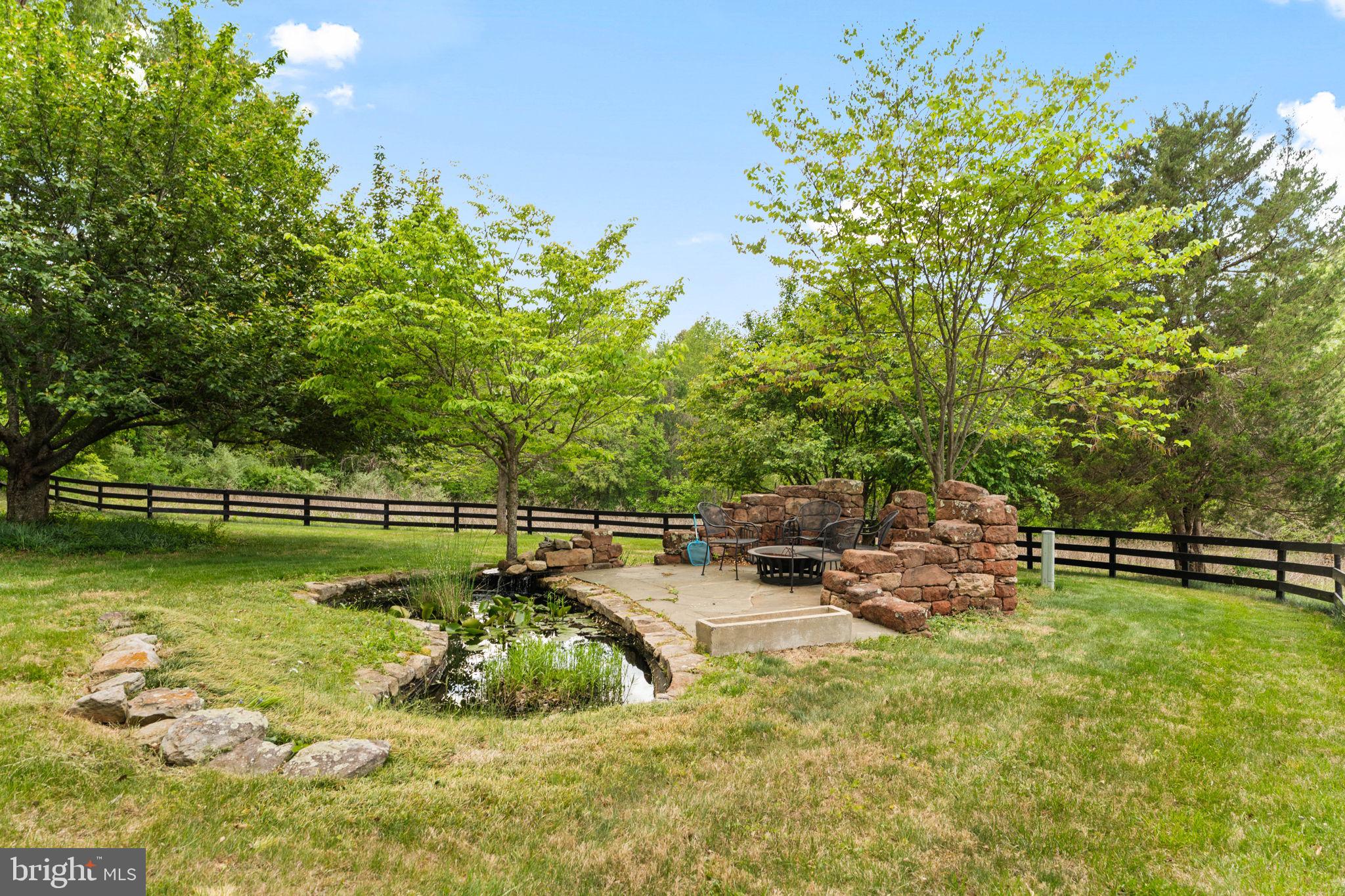 324 North Blue Ridge Turnpike Madison, VA 22727 - Photo 43 of 75 a view of a swimming pool with a bench and trees in the background