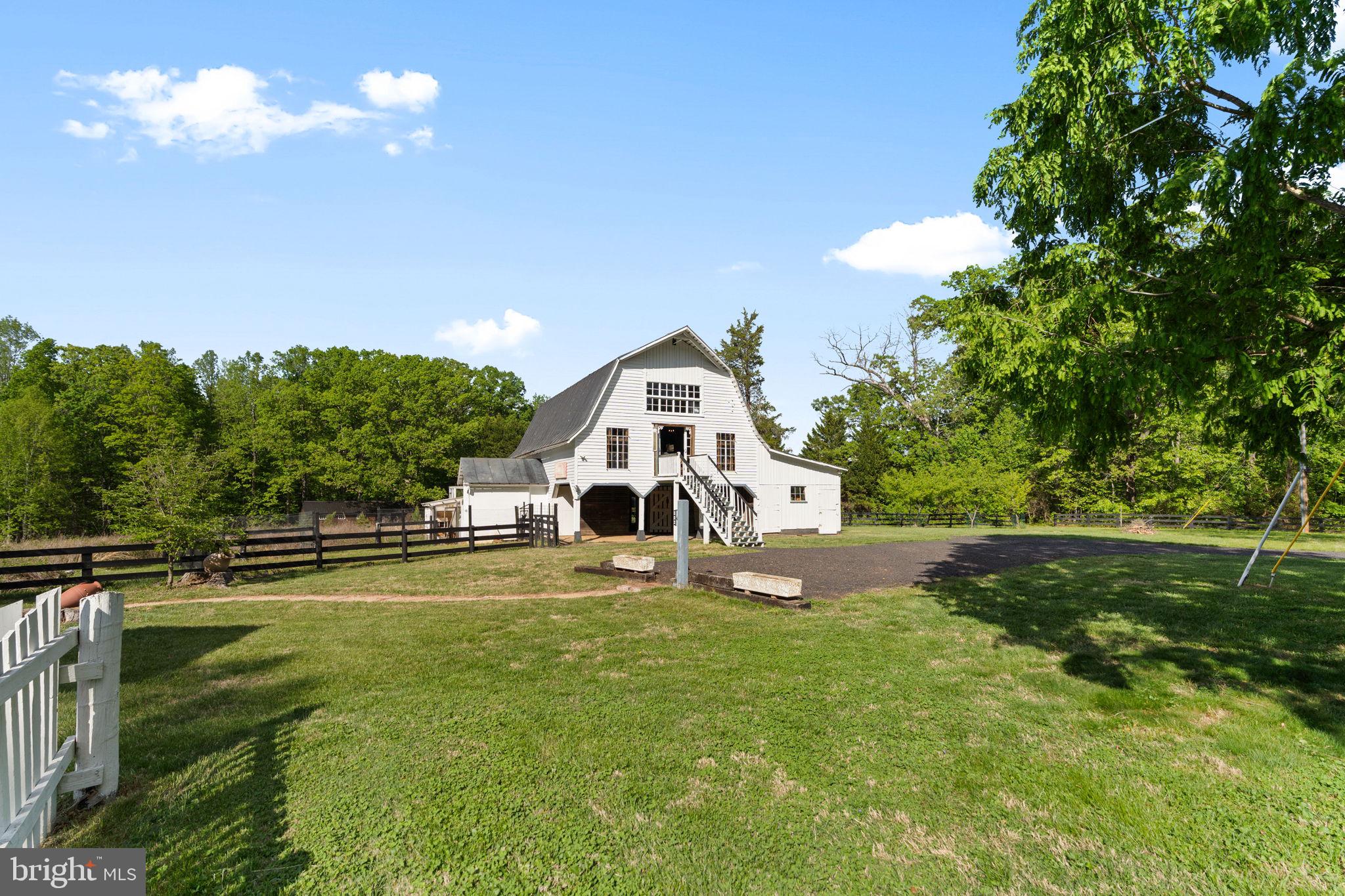 324 North Blue Ridge Turnpike Madison, VA 22727 - Photo 56 of 75 a white house with a big yard and large trees with wooden fence