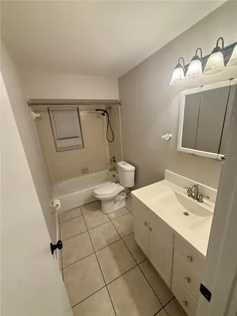 a bathroom with a sink toilet and mirror