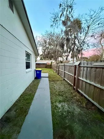 a view of house with backyard