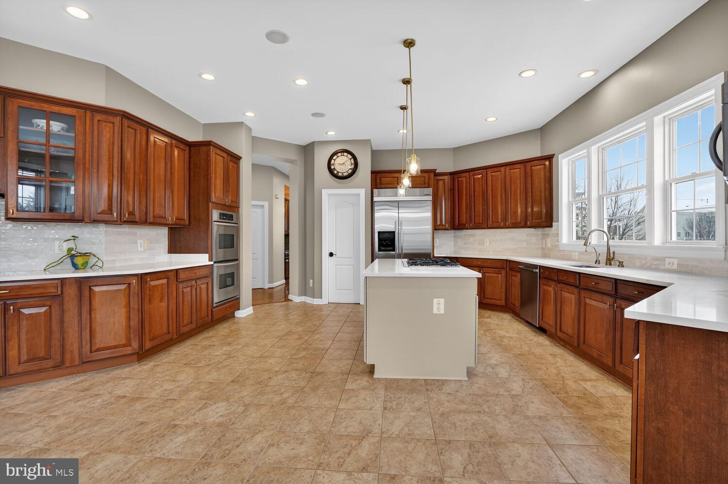 43024 La Riva Drive Ashburn, VA 20148 - Photo 12 of 63 a large kitchen with a large counter top stainless steel appliances and cabinets