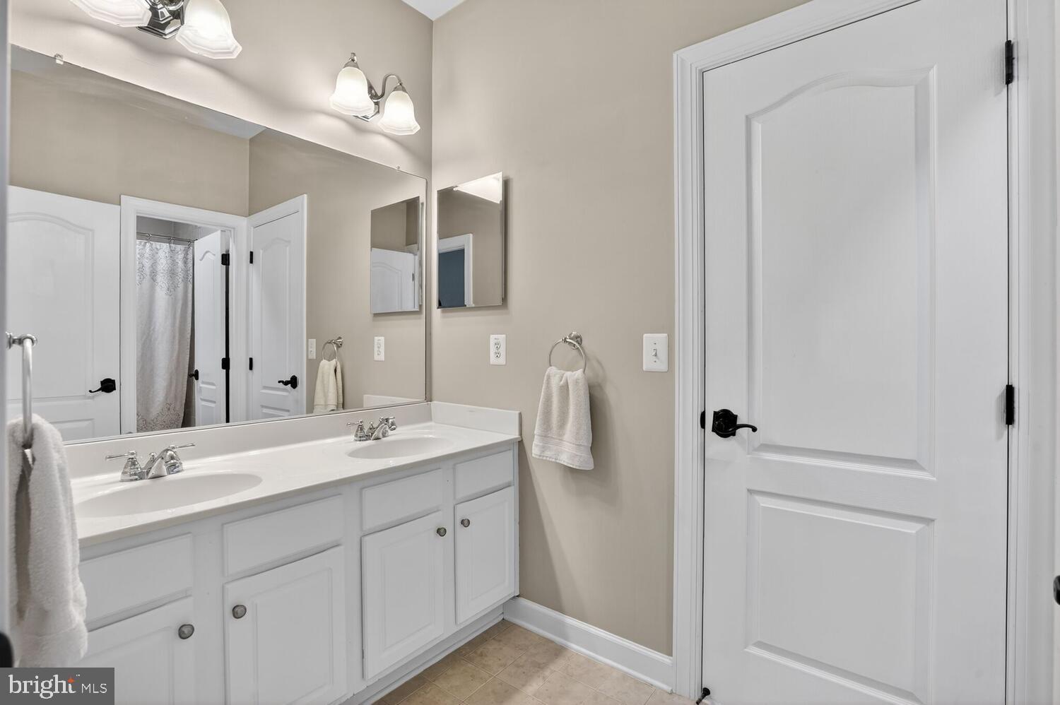 43024 La Riva Drive Ashburn, VA 20148 - Photo 47 of 63 a spacious bathroom with a double vanity sink a mirror and a shower