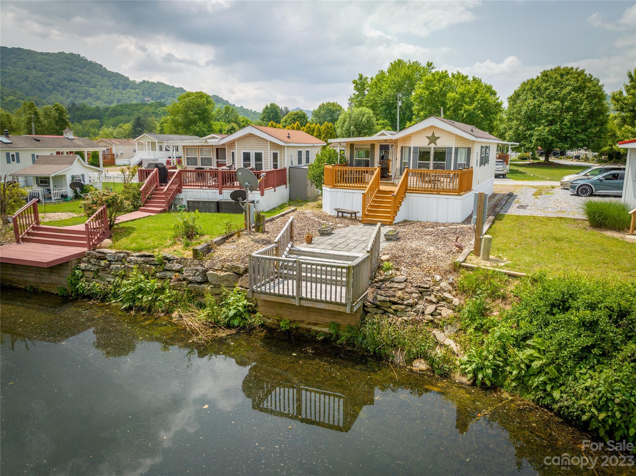 230 Pike Point Waynesville, NC 28785 - Photo 1 of 30 an aerial view of a house with swimming pool lake view and mountain view