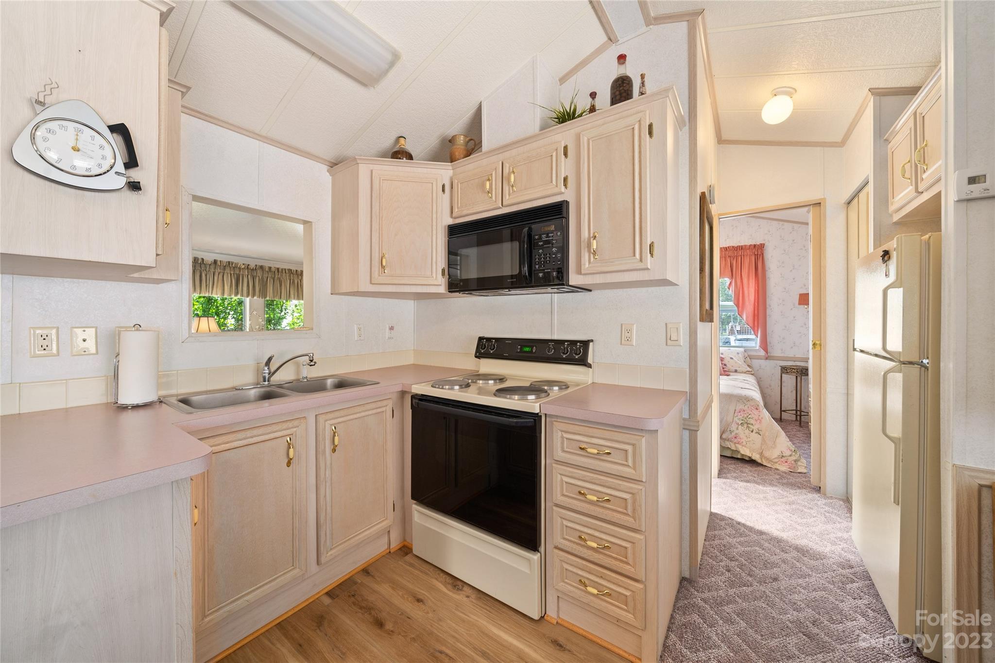 230 Pike Point Waynesville, NC 28785 - Photo 16 of 30 a kitchen with stainless steel appliances a stove refrigerator sink and microwave