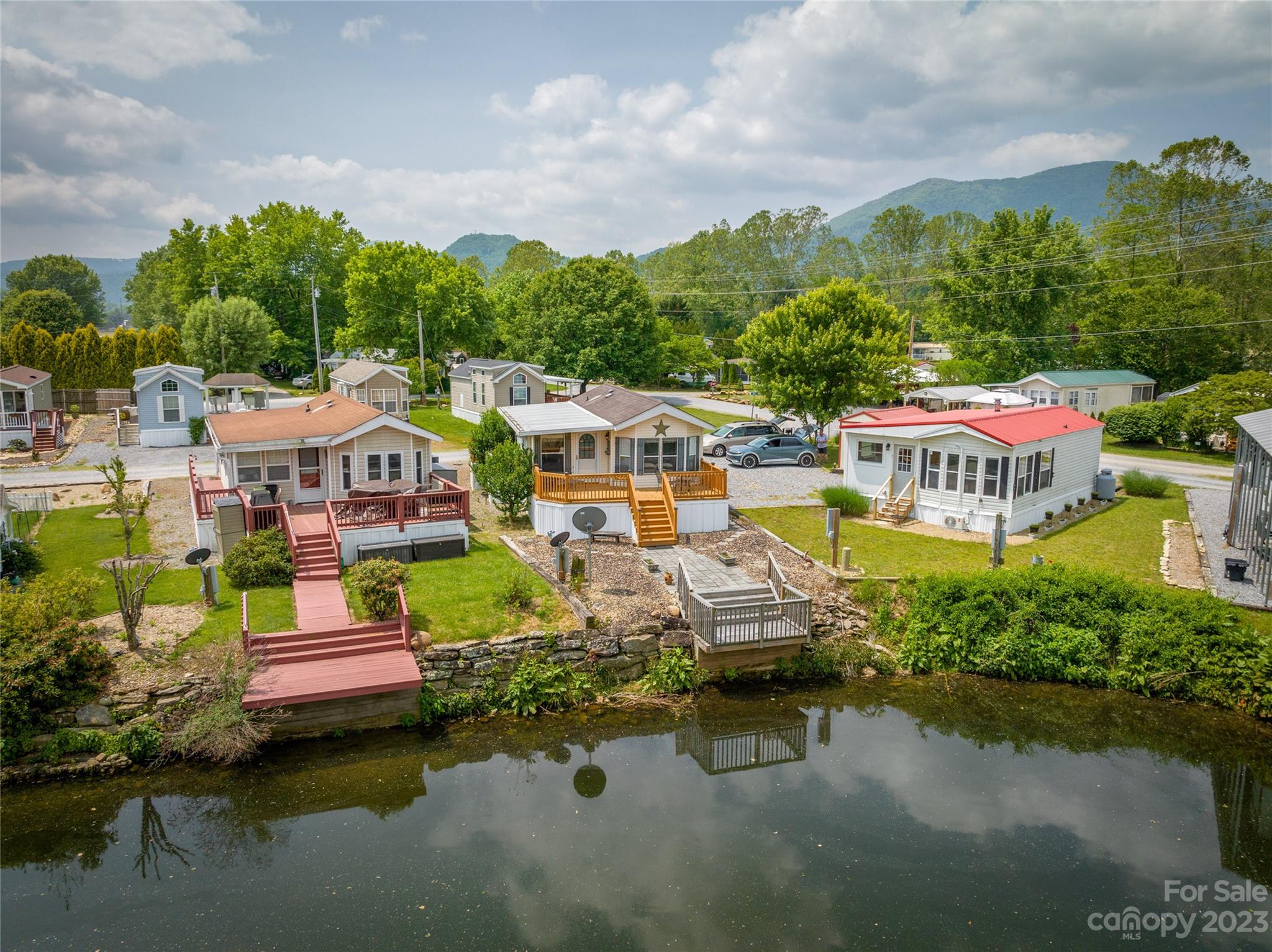 230 Pike Point Waynesville, NC 28785 - Photo 27 of 30 a aerial view of a house with swimming pool and lake view
