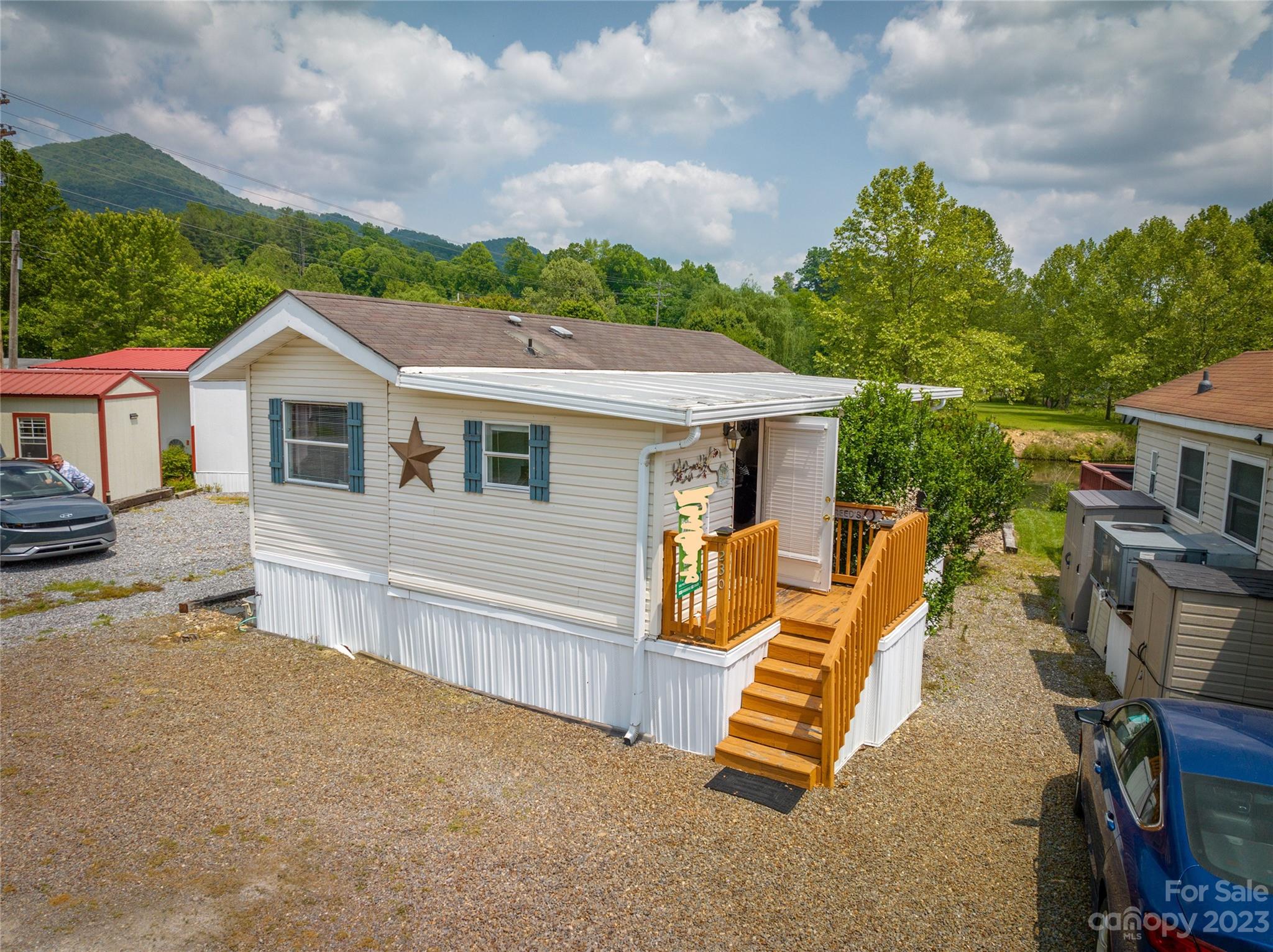 230 Pike Point Waynesville, NC 28785 - Photo 9 of 30 a view of a house with a yard porch and wooden fence