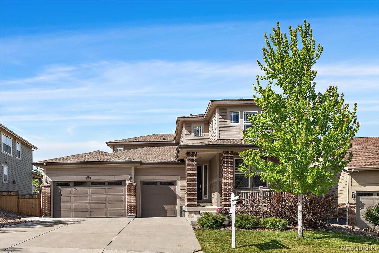 16062 Red Bud Loop Parker, CO 80134 - Photo 1 of 36 a front view of a house with a garden