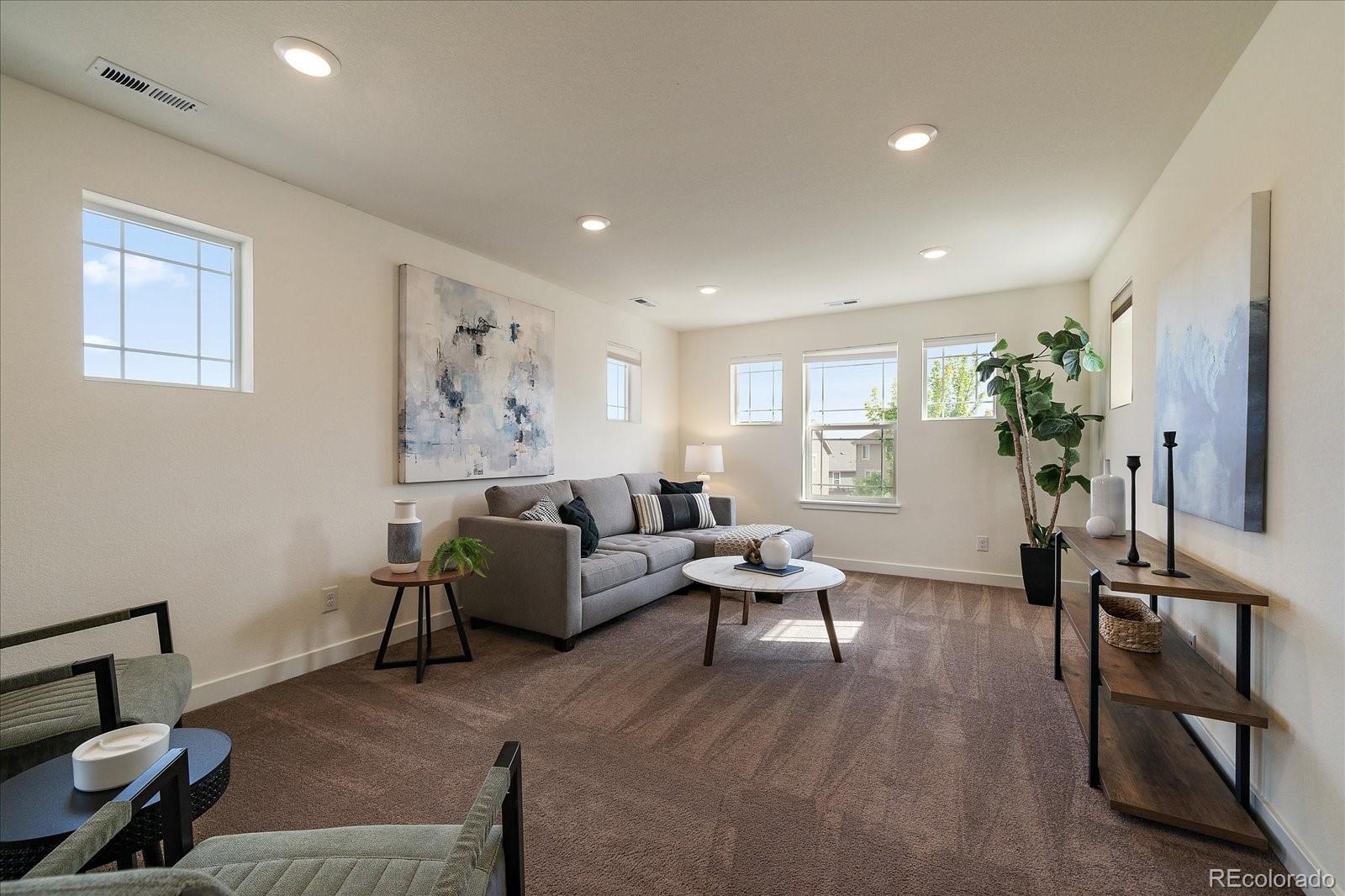 16062 Red Bud Loop Parker, CO 80134 - Photo 19 of 36 a living room with furniture and a wooden floor
