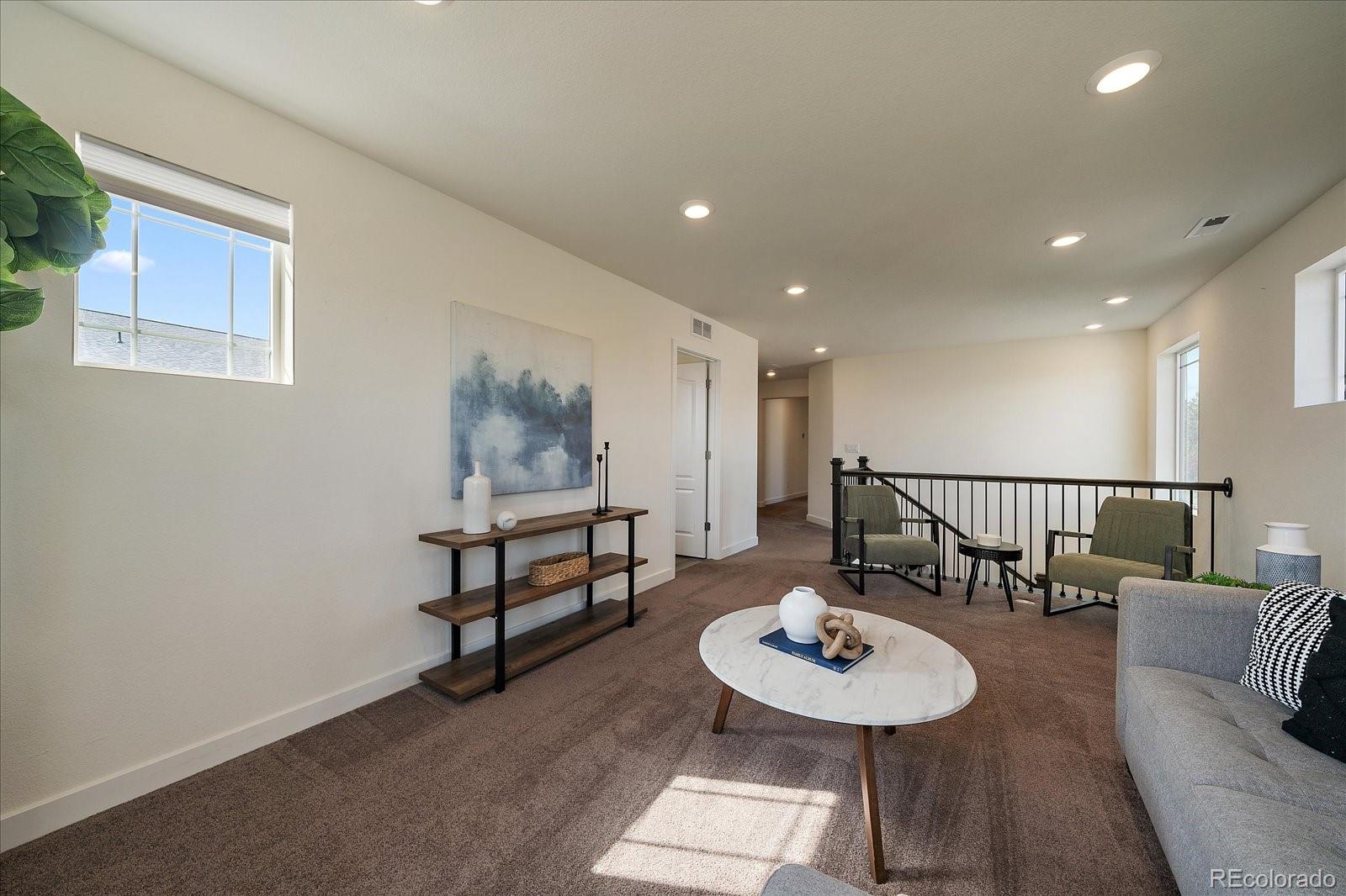 16062 Red Bud Loop Parker, CO 80134 - Photo 21 of 36 a living room with furniture and a wooden floor