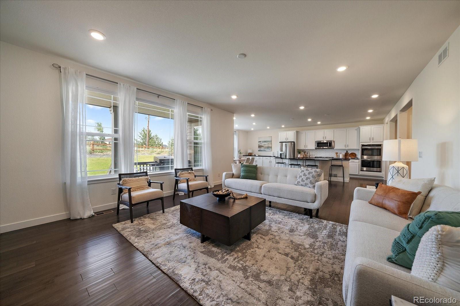 16062 Red Bud Loop Parker, CO 80134 - Photo 5 of 36 a living room with furniture and a table