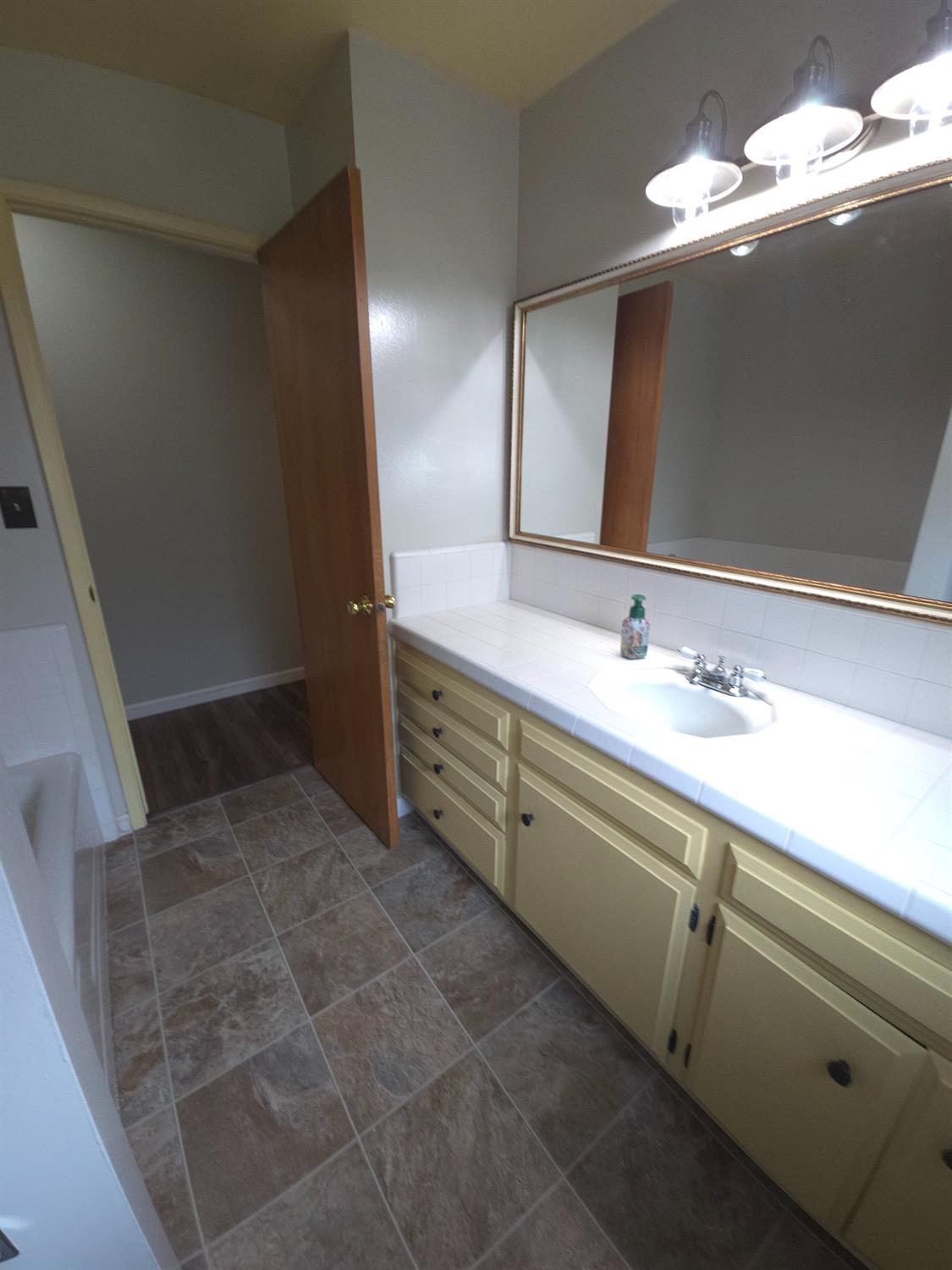 1601 Jacquelyn Way Modesto, CA 95355 - Photo 15 of 23 a bathroom with a sink a vanity and a mirror
