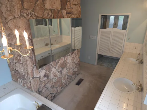 a kitchen with stainless steel appliances granite countertop a refrigerator a sink and a stove