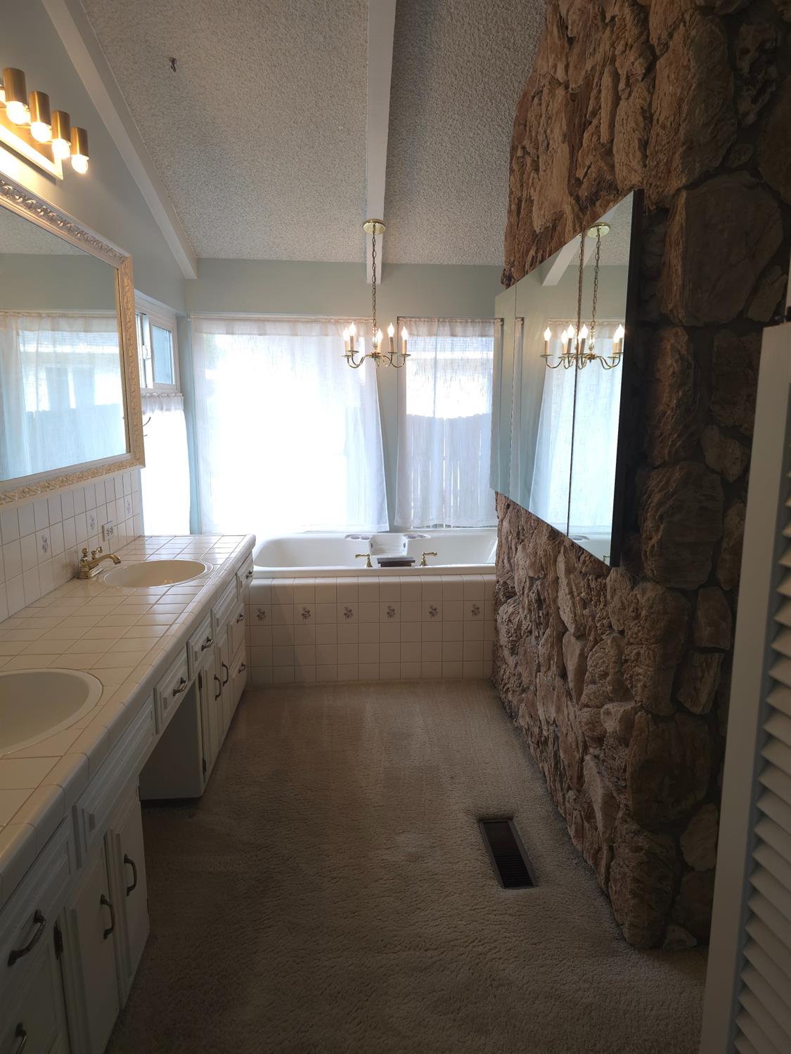1601 Jacquelyn Way Modesto, CA 95355 - Photo 10 of 23 a large bathroom with a double vanity sink and a mirror