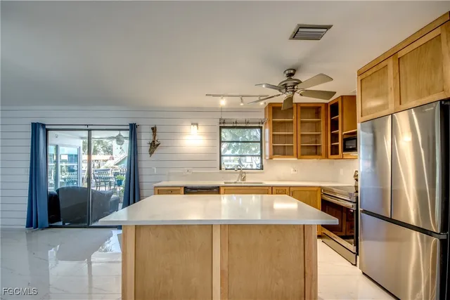 a living room with furniture and a floor to ceiling window