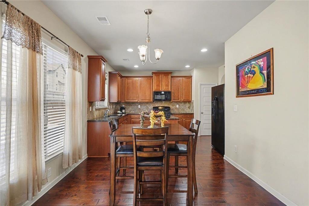 12155 Centerra Drive Hampton, GA 30228 - Photo 12 of 31 a view of a dining room with furniture window and wooden floor