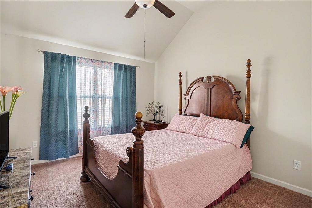 12155 Centerra Drive Hampton, GA 30228 - Photo 22 of 31 a bedroom with a bed and a flat screen tv