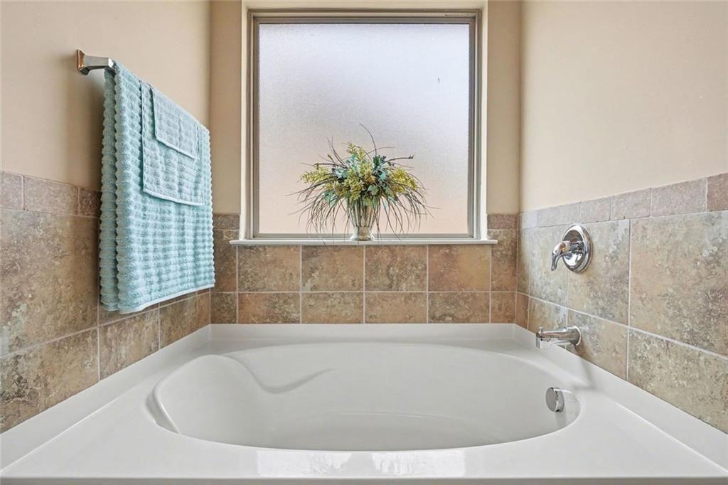 12155 Centerra Drive Hampton, GA 30228 - Photo 25 of 31 a bathroom with bathtub and window