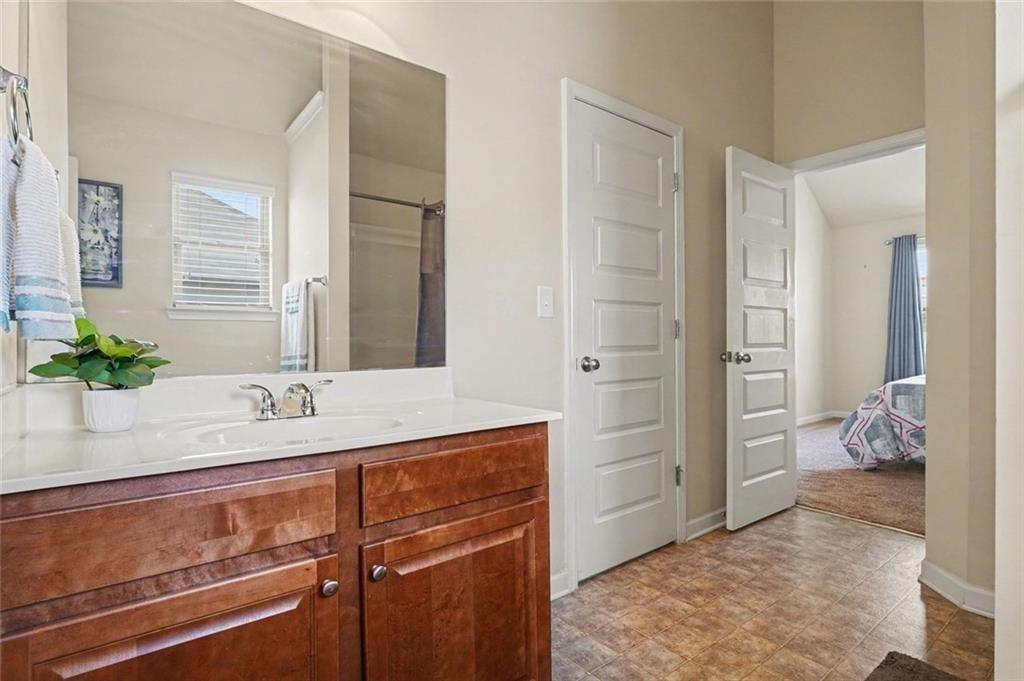 12155 Centerra Drive Hampton, GA 30228 - Photo 27 of 31 a bathroom with a sink and a mirror