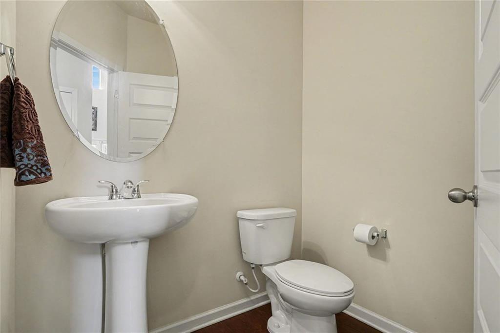 12155 Centerra Drive Hampton, GA 30228 - Photo 28 of 31 a bathroom with a sink a mirror and toilet