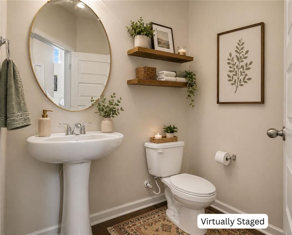 12155 Centerra Drive Hampton, GA 30228 - Photo 29 of 31 a bathroom with a toilet a sink and a mirror