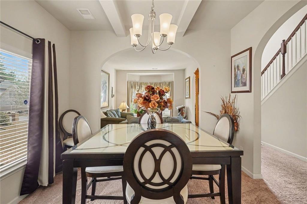 12155 Centerra Drive Hampton, GA 30228 - Photo 9 of 31 a view of a a dining room with furniture window and wooden floor
