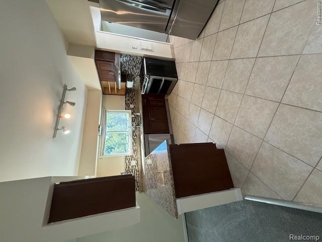 43038 Hanford Road Canton, MI 48187 - Photo 15 of 36 Kitchen featuring tile flooring, dark wood-finish cabinetry, speckled countertops, a mosaic tile backsplash, and stainless steel appliances