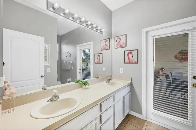 a bathroom with a double vanity sink and a mirror