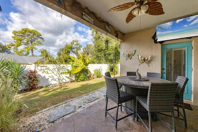 a view of an outdoor dining space with a table and chairs