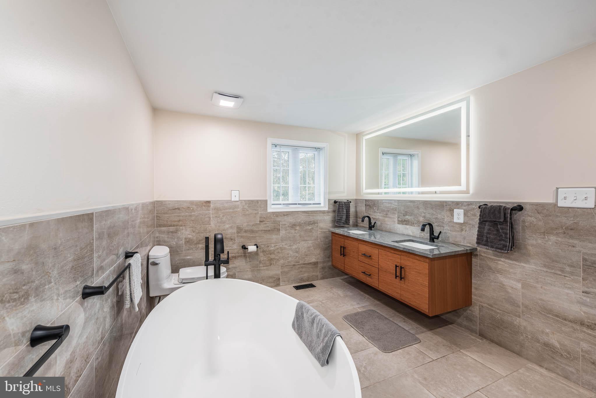 2705 Spring Hill Road Pikesville, MD 21208 - Photo 17 of 43 a bathroom with sink mirror and bathtub