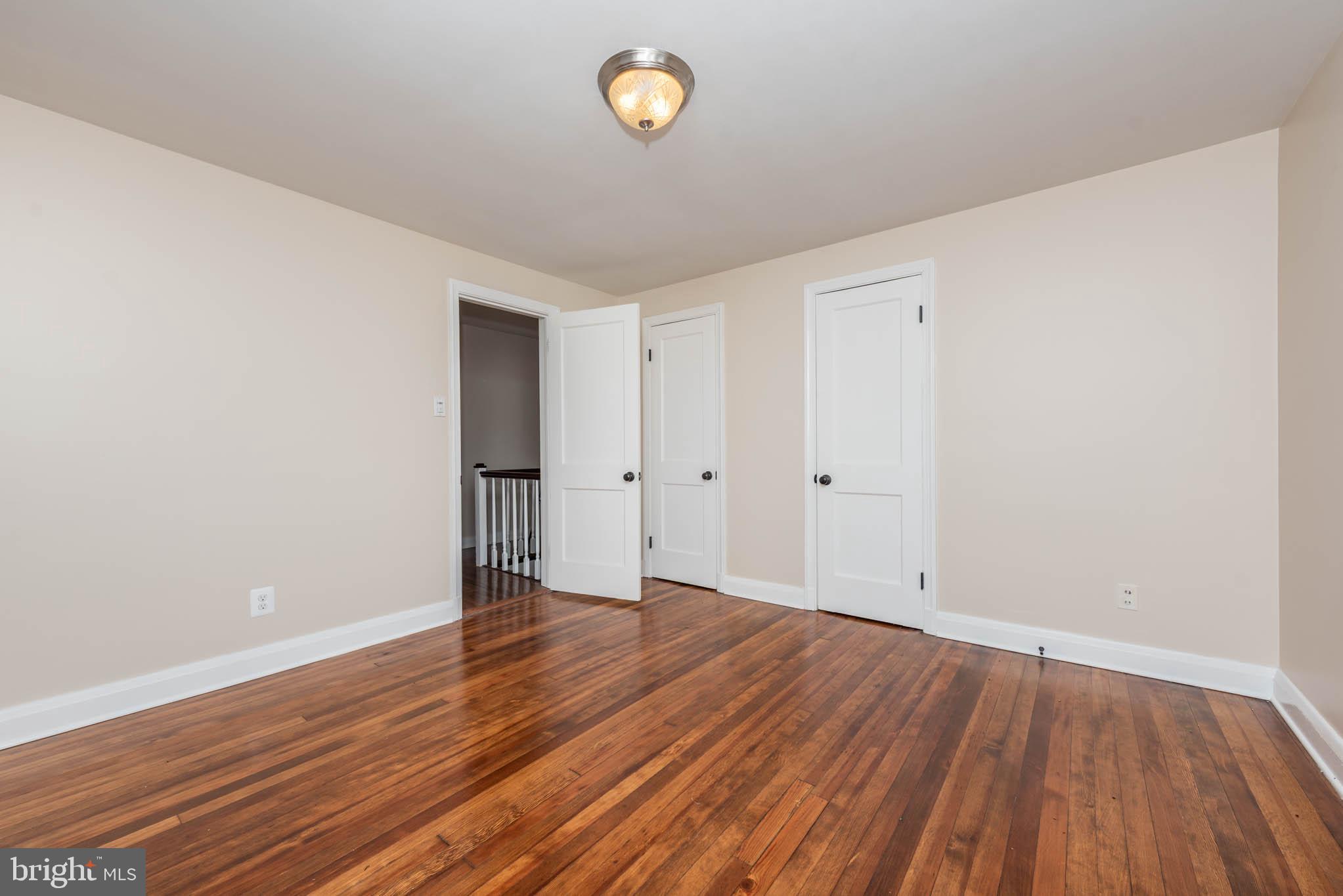 2705 Spring Hill Road Pikesville, MD 21208 - Photo 23 of 43 a view of an empty room with wooden floor and a window
