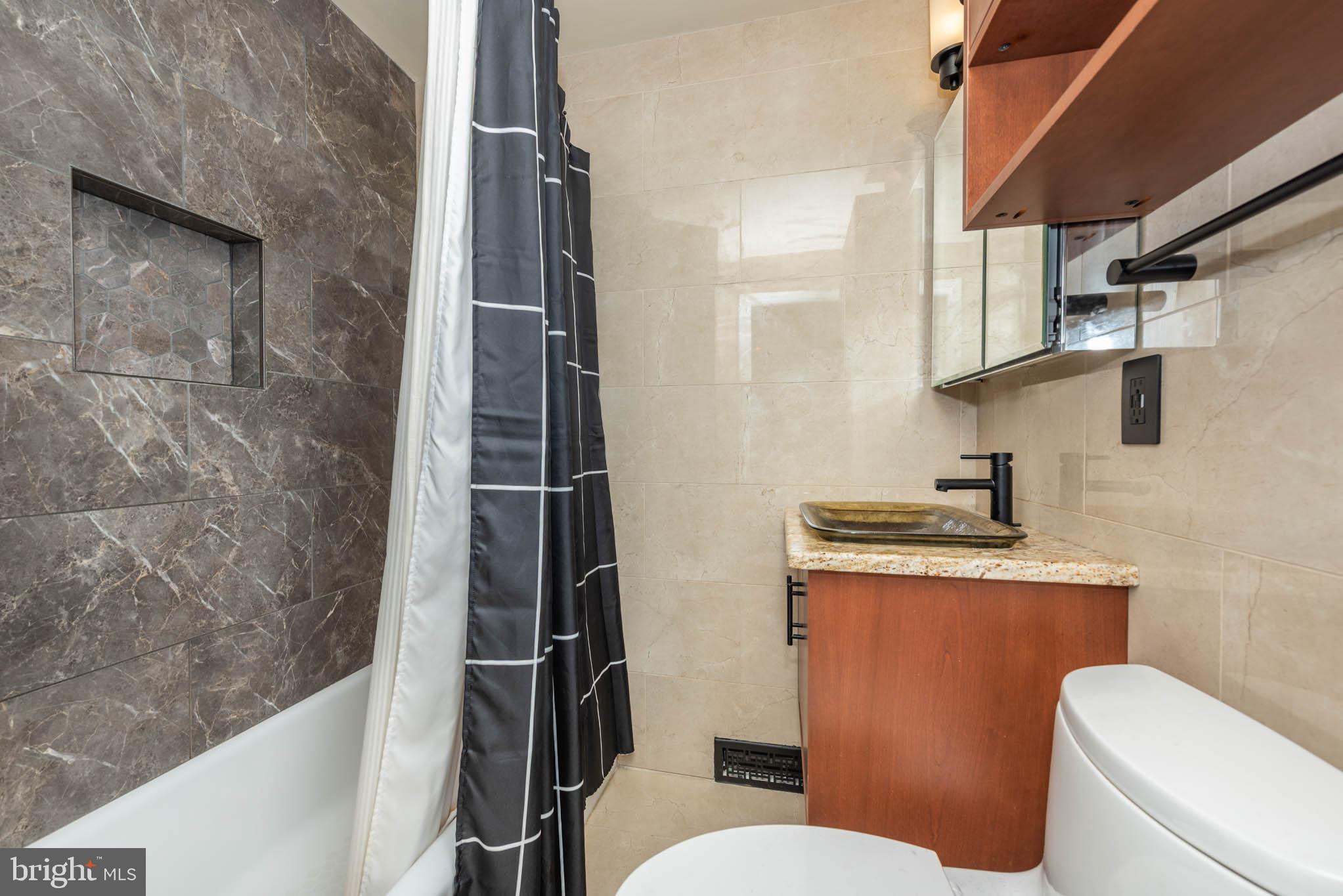 2705 Spring Hill Road Pikesville, MD 21208 - Photo 24 of 43 a bathroom with a granite countertop toilet sink and mirror