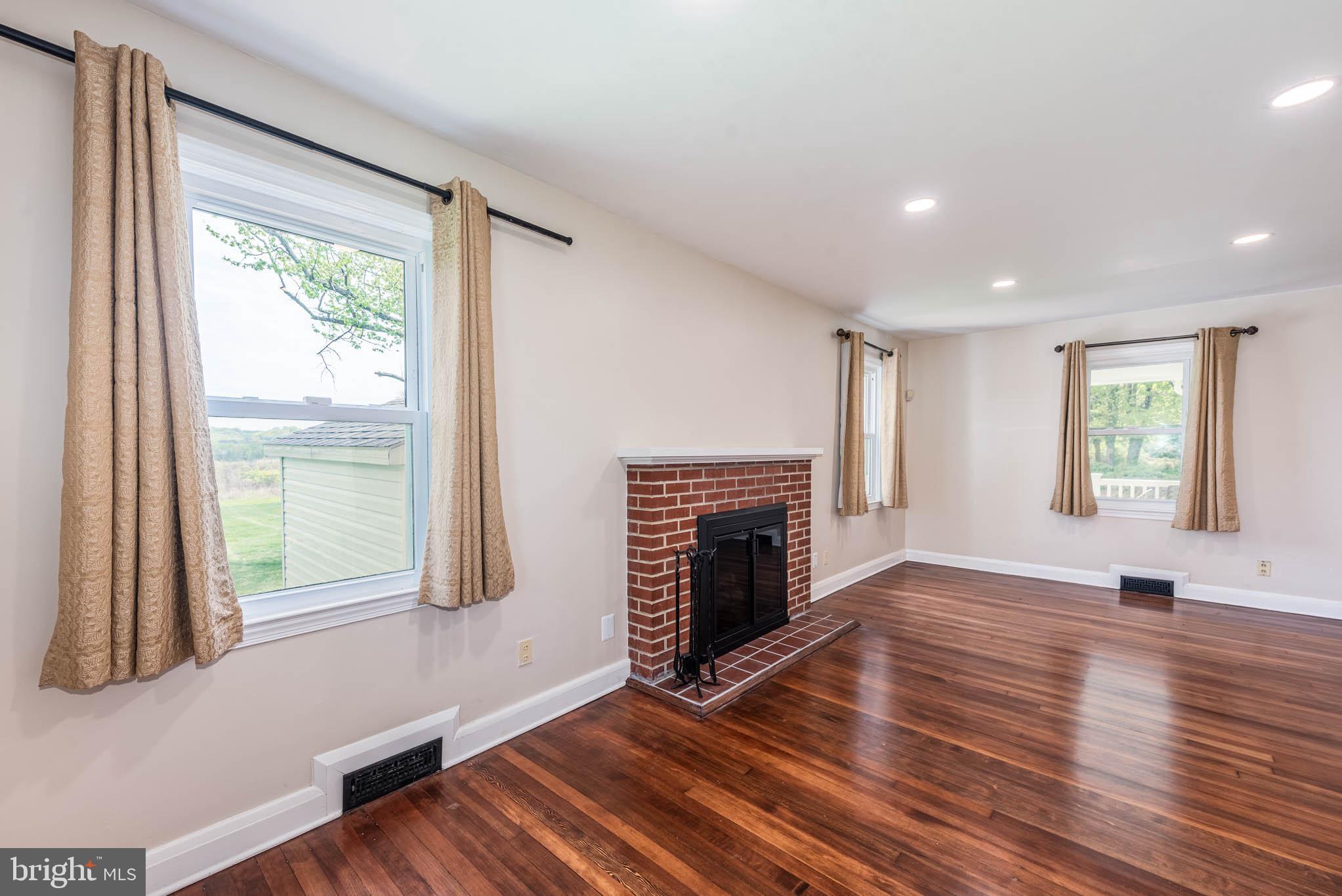 2705 Spring Hill Road Pikesville, MD 21208 - Photo 4 of 43 a view of an empty room with wooden floor and a window