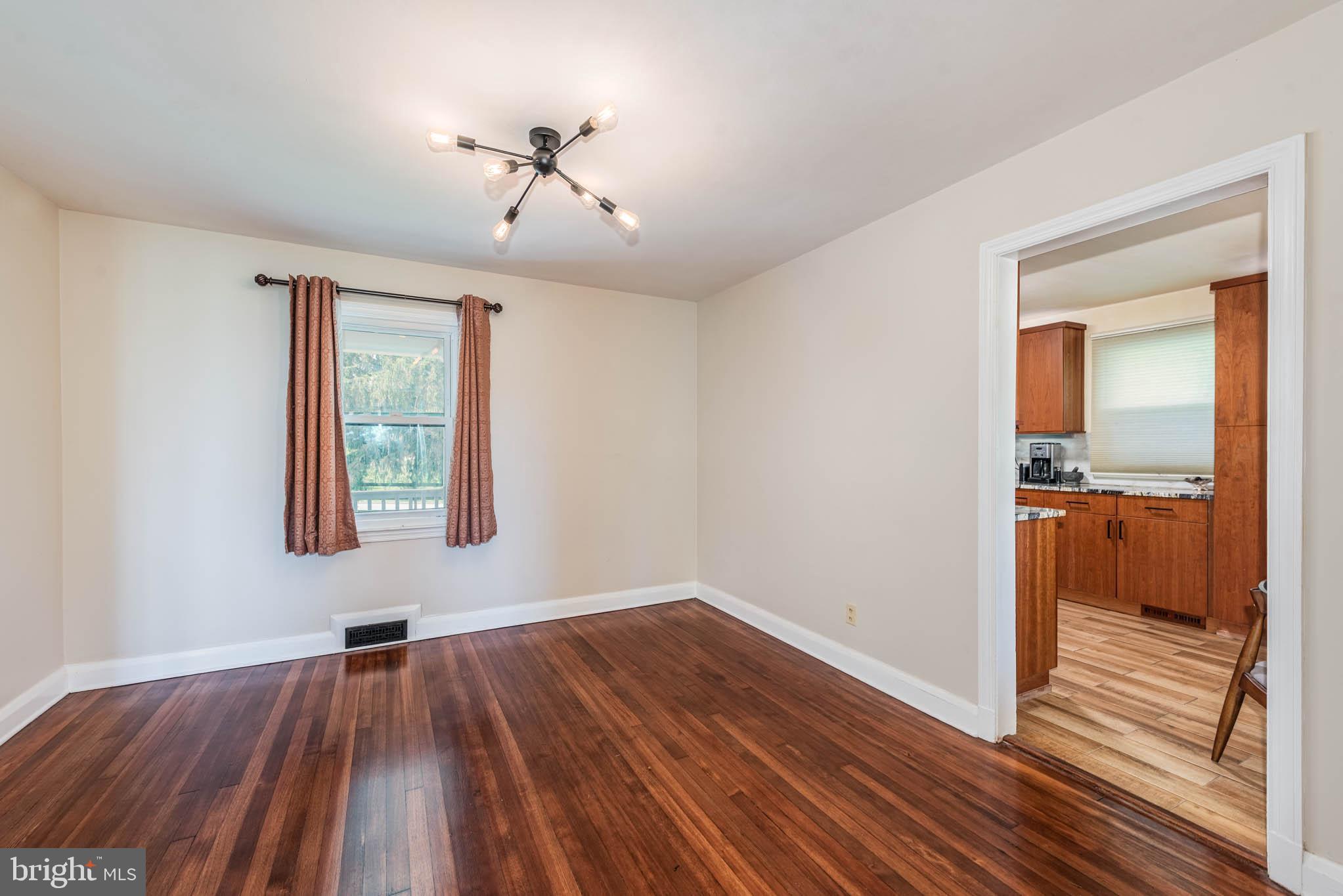 2705 Spring Hill Road Pikesville, MD 21208 - Photo 6 of 43 a view of hallway with a large window and wooden floor