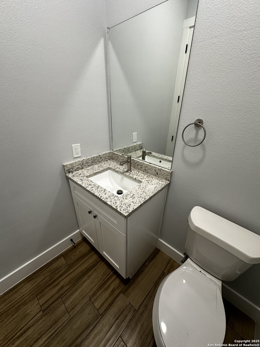 327 Ebner Street, Unit B Boerne, TX 78006 - Photo 7 of 21 a bathroom with a toilet sink and mirror