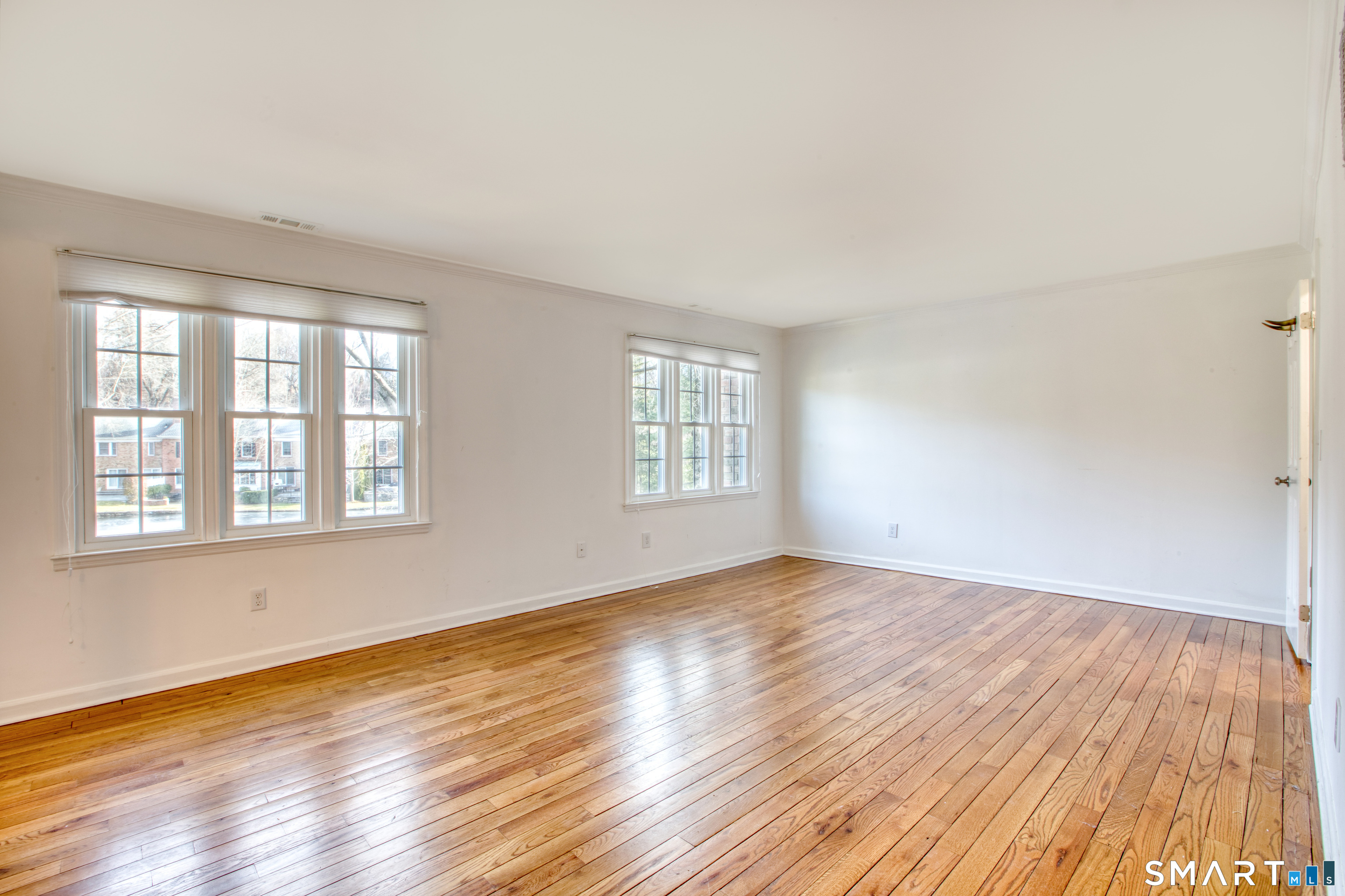 9 Georgetowne North Greenwich, CT 06831 - Photo 21 of 35 an empty room with wooden floor and windows