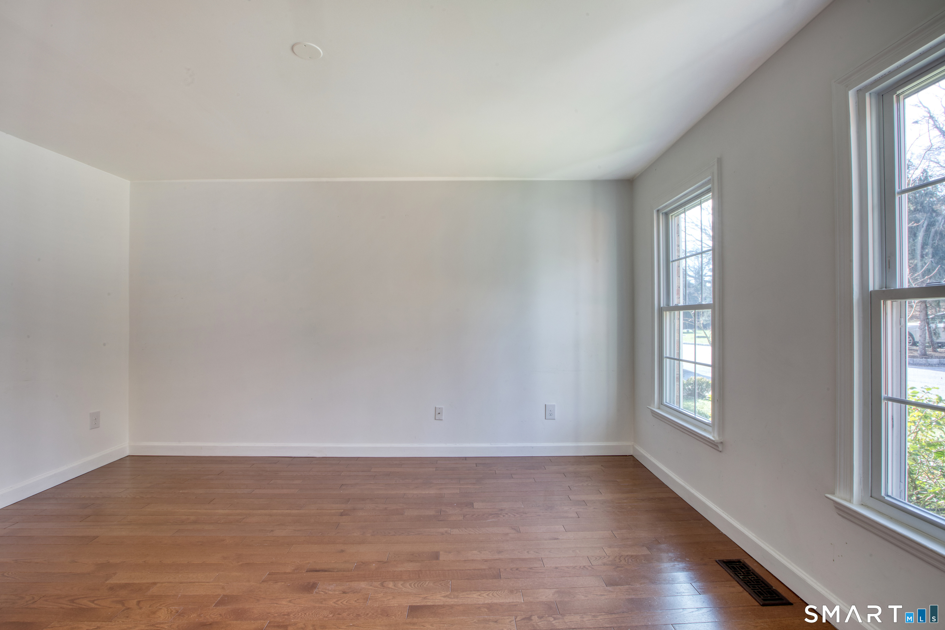 9 Georgetowne North Greenwich, CT 06831 - Photo 23 of 35 an empty room with wooden floor and windows