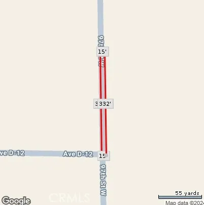 a street sign sitting on a wall next to a white wall