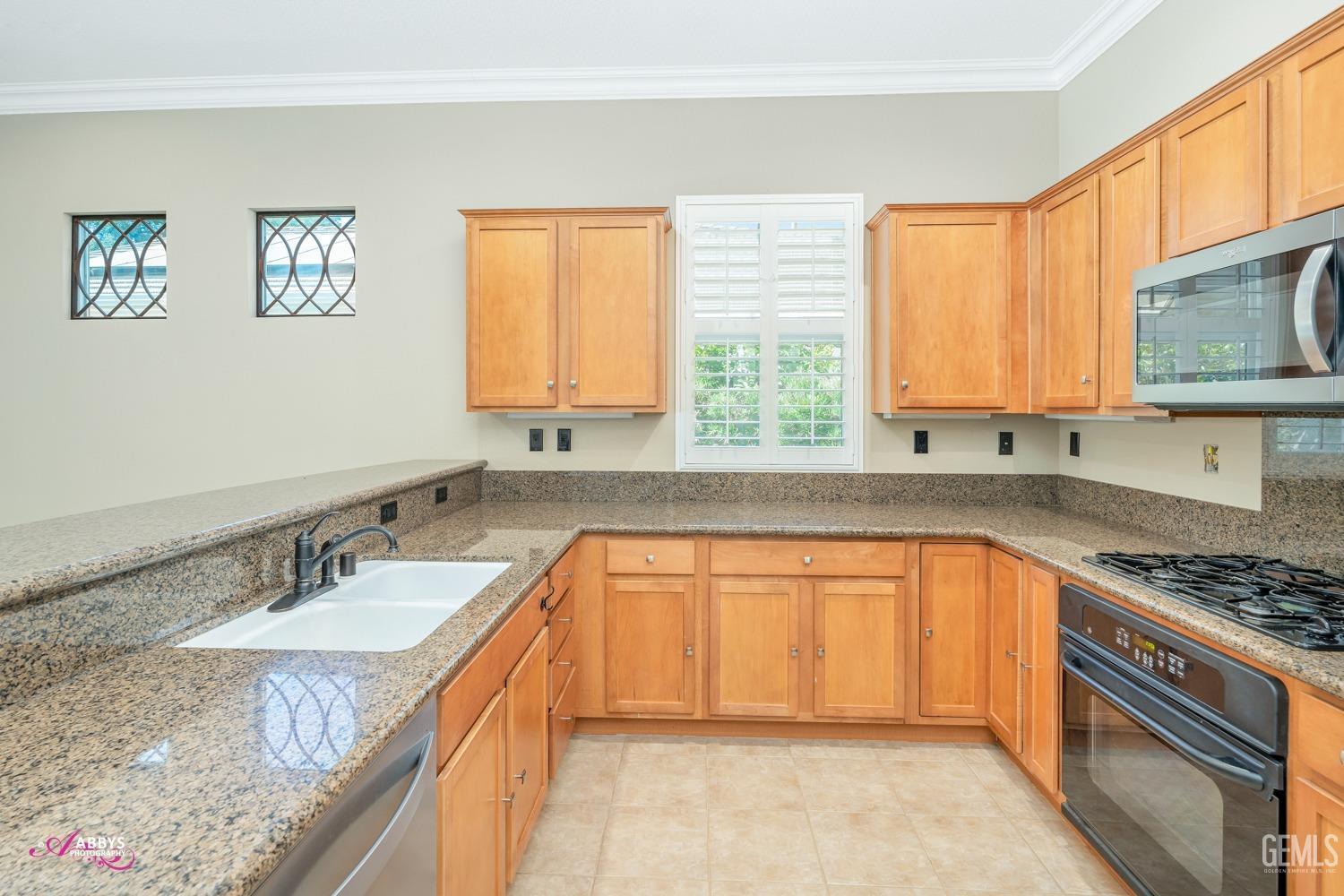 Undisclosed Address Bakersfield, CA 93306 - Photo 12 of 49 a kitchen with stainless steel appliances granite countertop a sink stove and cabinets